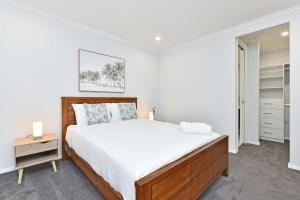 a bedroom with a large bed and a night stand at Huntlee Heights in North Rothbury