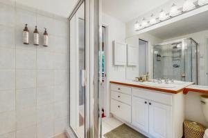 a white bathroom with a shower and a sink at The Canopy House in Eugene +16 photos