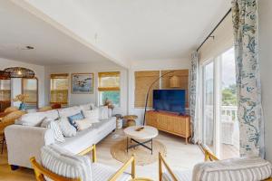 a living room with a couch and a tv at Entire House - Serenity in Surf City in Surf City