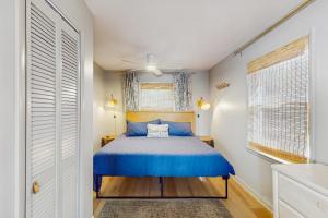 a bedroom with a blue bed and a window at Entire House - Serenity in Surf City in Surf City