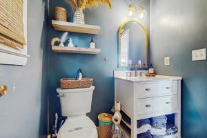 a bathroom with a sink and a toilet and a mirror at Entire House - Serenity in Surf City in Surf City +21 photos