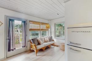 a living room with a couch and a refrigerator at Entire House - Serenity in Surf City in Surf City