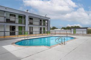 a swimming pool in front of a building at SureStay by Best Western Victoria in Victoria