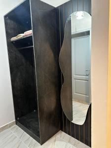 a bathroom with a large mirror on the wall at B15/87/41 · Brand New 3BR Stylish Madinaty in Madinaty