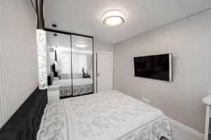 a bedroom with a bed and a television in it at Anna ApartHotel in Chişinău +2 photos
