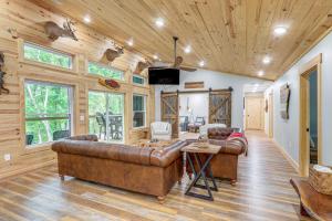 a living room with a leather couch and a tv at Relax on the River Modern Mountain View Escape! in Mountain View
