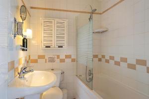 a bathroom with a sink and a toilet and a shower at Résidence Chlorophylle - Arcueil in Arcueil