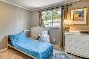 a childs bedroom with a blue bed and a window at Modern Home Close to Dtwn Woodinville with Yard in Woodinville