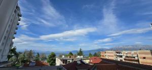 a view of the city from the roofs of buildings at Luxury lakeview apartment in Pogradec