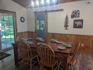 a dining room with a wooden table and chairs at Cabin in the Woods at J and J's in Jasper