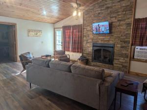 a living room with a couch and a fireplace at Cabin in the Woods at J and J's in Jasper