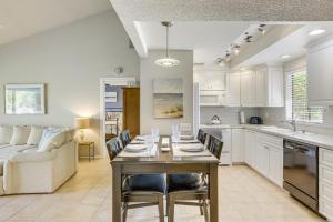 a kitchen and living room with a table and chairs at Golf and Swim Country Club Condo in Palm Desert in Palm Desert