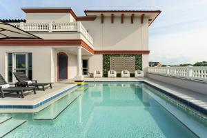 a villa with a swimming pool and a house at Hotel Amalga, St. Augustine, A Tribute Portfolio Hotel in St. Augustine