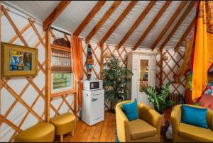 a room with two chairs and a stove in a room at Mystical Moroccan Yurt - Unit #5 in Waco