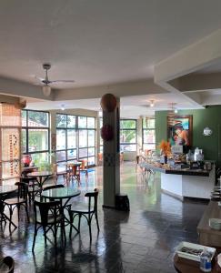 a restaurant with tables and chairs in a room at Pousada Sol do Araguaia in Barra do Garças