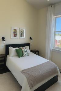 a bedroom with a large white bed and a window at Il Capitano - Little Torch Key in Little Torch Key