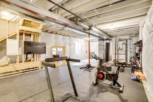 a gym with several tread machines and a flat screen tv at Less Than 2 Mi to Gaylord Rockies Remote-Work Hub with Gym! in Altura
