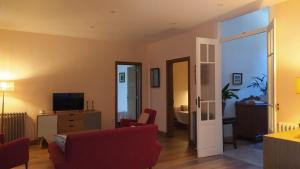 a living room with a red couch and a television at Casa San Amaro in San Amaro
