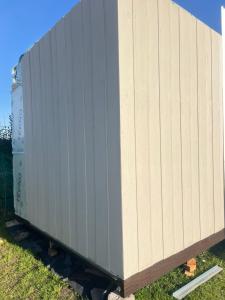 a gray train car sitting on the grass at Casa Acantilados Suites in Mar del Plata