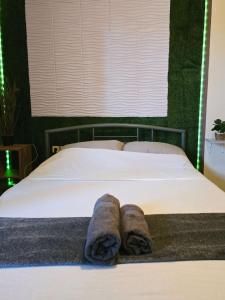 a bedroom with a bed with towels on it at The Green studio - Garden view in Lamía