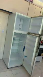 a refrigerator with its door open in a kitchen at Casas Paradisiaca Pagamento Automática in Caldas Novas