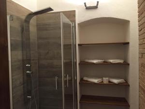 a shower with a glass door in a bathroom at Residenza Galligari in Foligno