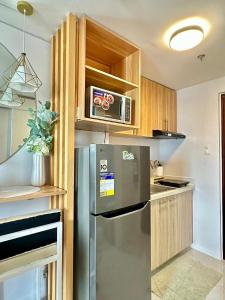 a kitchen with a stainless steel refrigerator and a microwave at Casa Amalia by Casa Mira Mandaue in Mandaue City +3 photos