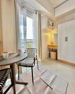 a kitchen with a table and a chair and a window at Casa Amalia by Casa Mira Mandaue in Mandaue City