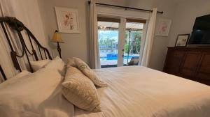 a bedroom with a bed with white pillows and a window at Intercoastal Waterfront House in Pompano Beach +42 photos