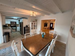 a kitchen and dining room with a wooden table and chairs at Intercoastal Waterfront House in Pompano Beach