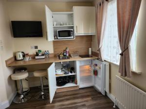 a small kitchen with a desk and a microwave at Lovely Private Room in Dublin
