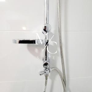 a shower head in a bathroom with a faucet at Exclusivo con Espectacular Vista al mar in Antofagasta +23 photos