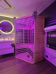 a pink bathroom with a shower and a sink at Romance House in Arnouville-lès-Gonesse