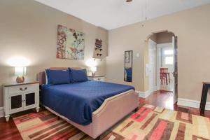 a bedroom with a blue bed and a rug at 1BR Apartment with WiFi & Laundry near Downtown in Carondelet +7 photos
