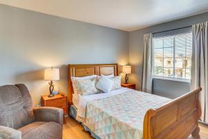 a bedroom with a bed and a chair and a window at 4 Mi to Las Vegas Strip Home with Covered Patio! in Las Vegas