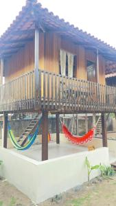 a playground with hammocks in front of a building at Chalés Soares e Sousa in Santarém