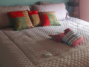 a white bed with pillows and a box on it at LeMarida Suites in Saint Peter