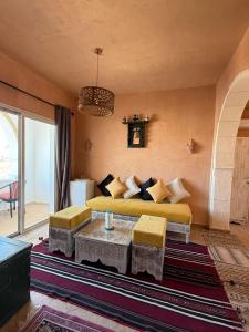 a bedroom with a yellow bed and a table at Résidence Ulysse Djerba in Mezraya +70 photos