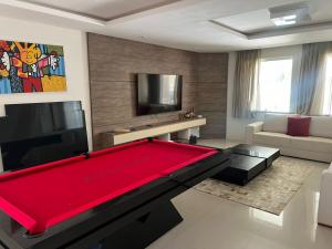 a living room with a large red pool table at Búzios Mansion Canal Area in Búzios