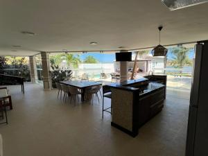a kitchen and dining room with a table and chairs at Búzios Mansion Canal Area in Búzios