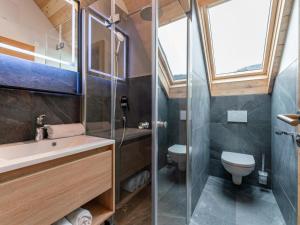 a bathroom with a sink and a toilet at Mountain Chalet Arnica in Sankt Lorenzen ob Murau +51 photos
