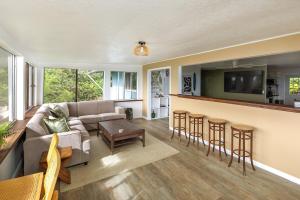 a living room with a couch and a bar at Lihau Boho House in Kailua-Kona