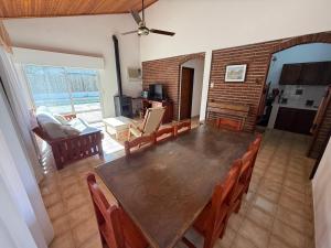 a dining room with a large wooden table and chairs at Casa Lago in Santa Ana