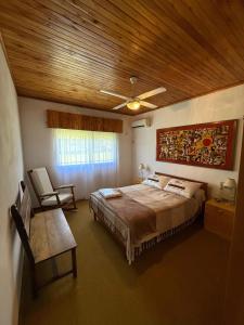 a bedroom with a large bed and a wooden ceiling at Casa Lago in Santa Ana