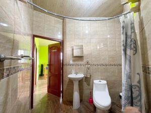 a bathroom with a toilet and a sink at Cabañas El Manantial in Esquipulas +40 photos