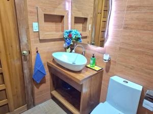 a bathroom with a sink and a toilet at Luxury Penthouse With View&Starlink in Dapa +17 photos