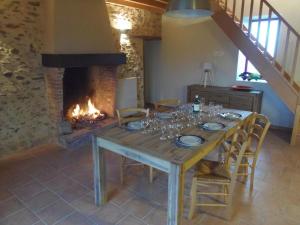 a dining room with a table and a fireplace at Gîte familial avec jardin clos à Falleron - FR-1-426-458 in Falleron
