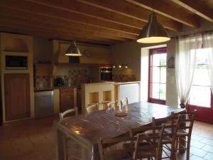 a kitchen with a large wooden table and chairs at Gîte familial avec jardin clos à Falleron - FR-1-426-458 in Falleron +11 photos