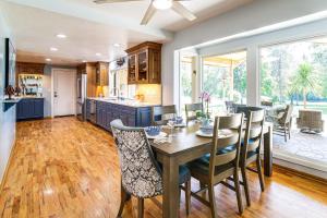 a kitchen and dining room with a table and chairs at Lovely Riverfront Grants Pass Home Pool and Hot Tub in Grants Pass