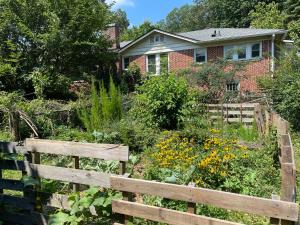a garden with a wooden fence in front of a house at Dog Friendly 1 bd 1 ba near Airport and Marta in Atlanta